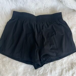 Aritzia TNAction black workout shorts